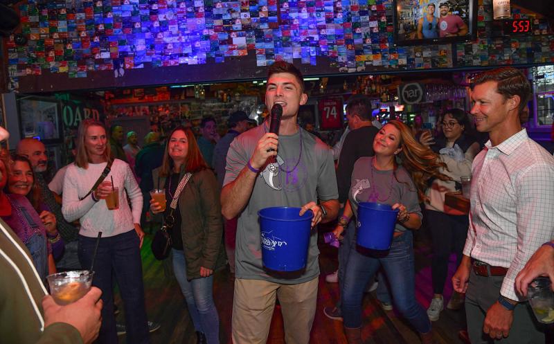 Singing “Sweet Caroline” to garner tips for the Beebe Goes Purple Fund is Carter McClung.