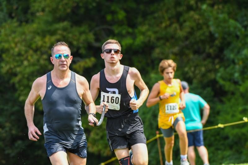 Dickinson senior Anthony Pipiro with guide runner Sean Gilligan.