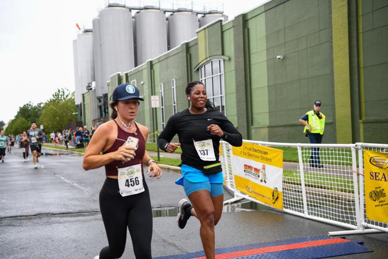 Julie Bare (39:37) and Tiarra Duffy Collins (40:30) cross the line together.