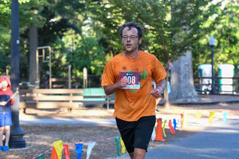 David Teklits crosses as the overall fastest runner in 19:20.47.