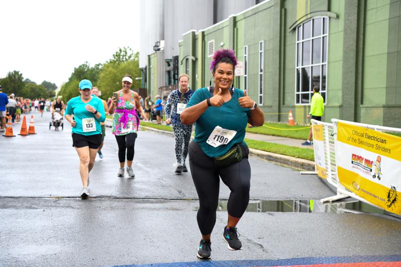Tessa Brooks (50:41) gives a thumbs-up as she crosses the finish line.