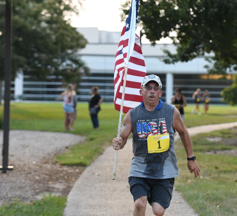 Allen Jackson runs with Old Glory to a time of 30:27.