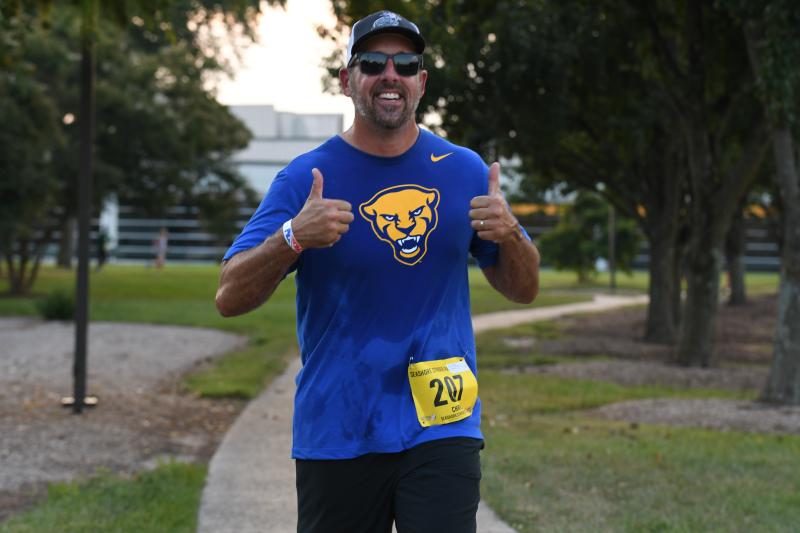 Chris Mergner gives a thumbs up on the way to a time of 35:23.