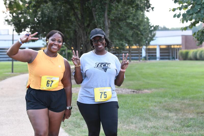 Shaila Collins and Kagan Rogers are all smiles as they finish the run/walk.