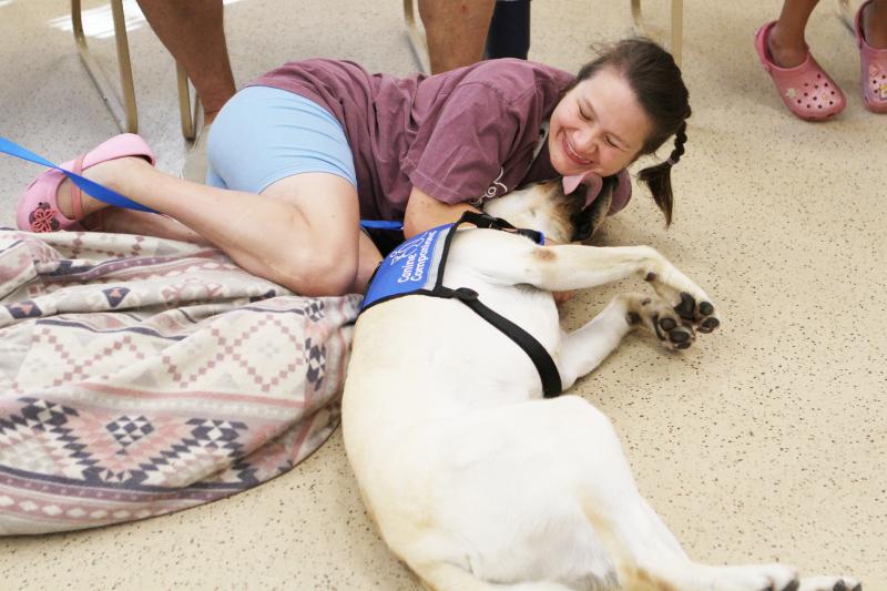 Jazmin Tinsley and Bonus take time for cuddles and kisses during team training at Canine Companions. SUBMITTED PHOTO