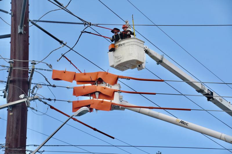 In a maze of power lines on Savannah Road, workers begin the task of relocating utilities to make way for the Old Orchard Road realignment project. RON MACARTHUR PHOTOS