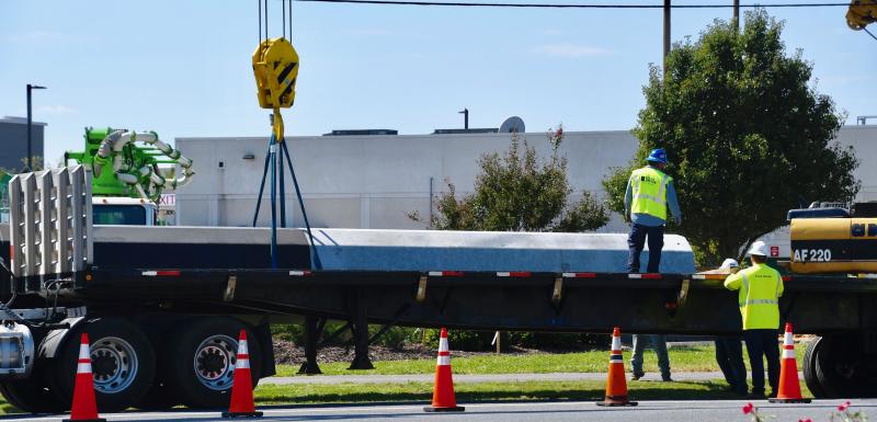 Workers remove a section of utility pole as part of the process of relocating utilities along Savannah Road and Wescoats Road.