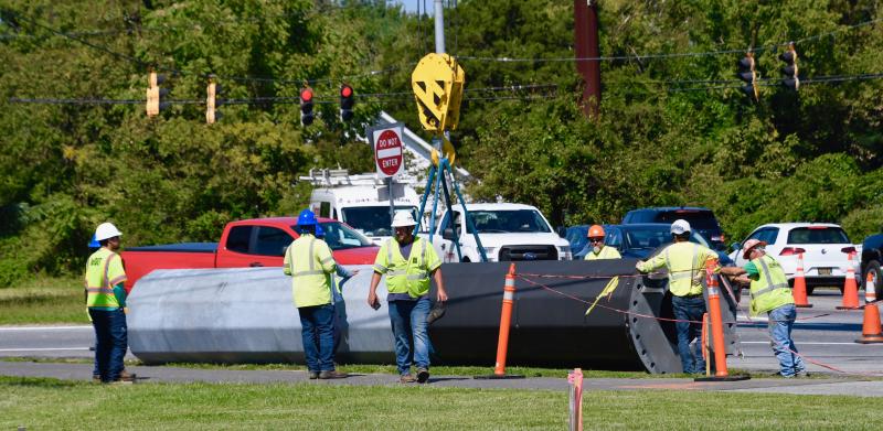 A large section of a new utility pole has just been offloaded Sept. 20. Drillers dug a 45-foot hole to anchor the pole.