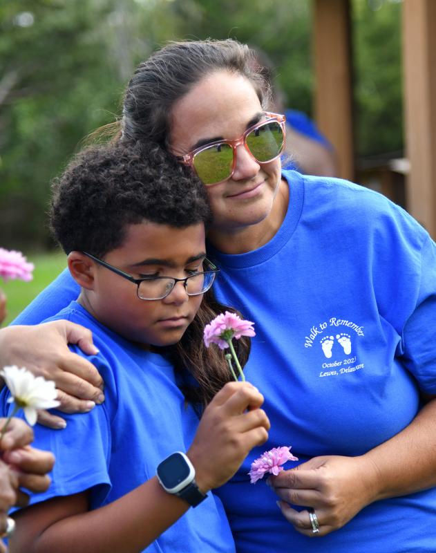 Ashley Collins and her son Malachi share a hug during the service.