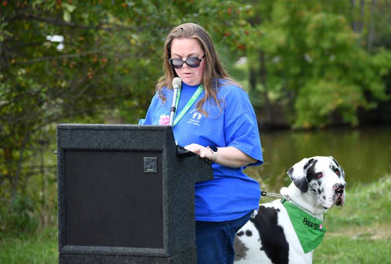 Laura Smith and therapy dog Sir read “I Walk to Remember” by Kathie Mayo.