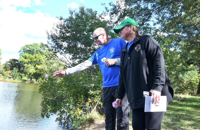Dennis, left, and Morgan Edgar toss a flower for their son, Waylon, who died in September after just seven days of life. DAN COOK PHOTOS