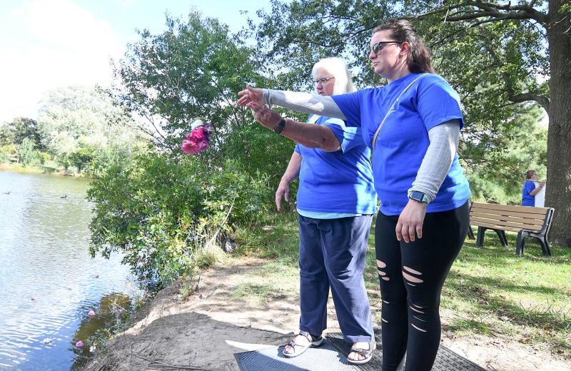 Terri Wyatt, left, and Katie McQuaid toss a bouquet to remember all perinatal losses.