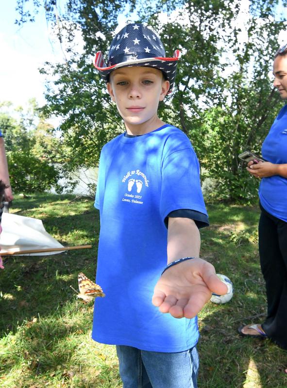 JJ McQuaid sets a butterfly free during the post-service release.