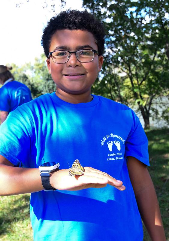 Malachi Collins frees a butterfly of remembrance.