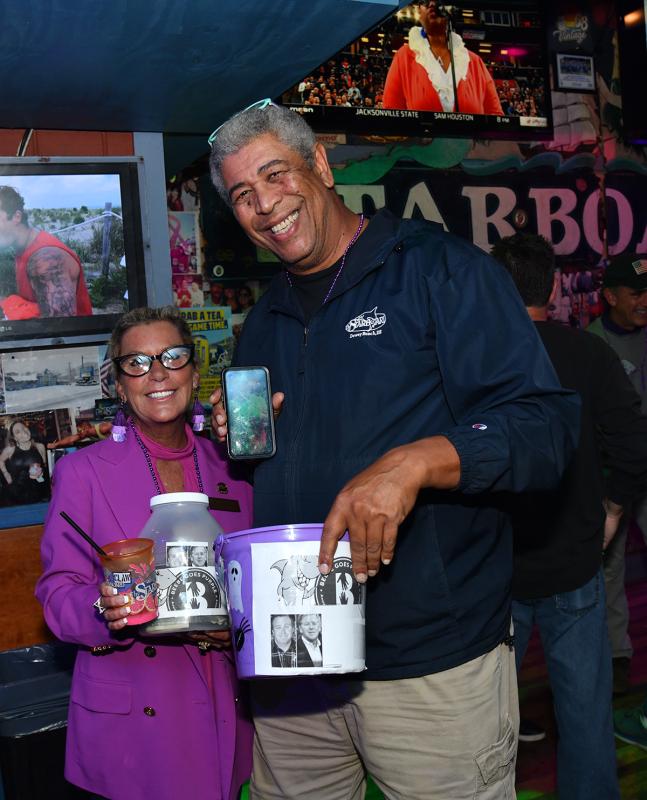 Jen Carroll, left, and Keith Warren accept donations at the event.
