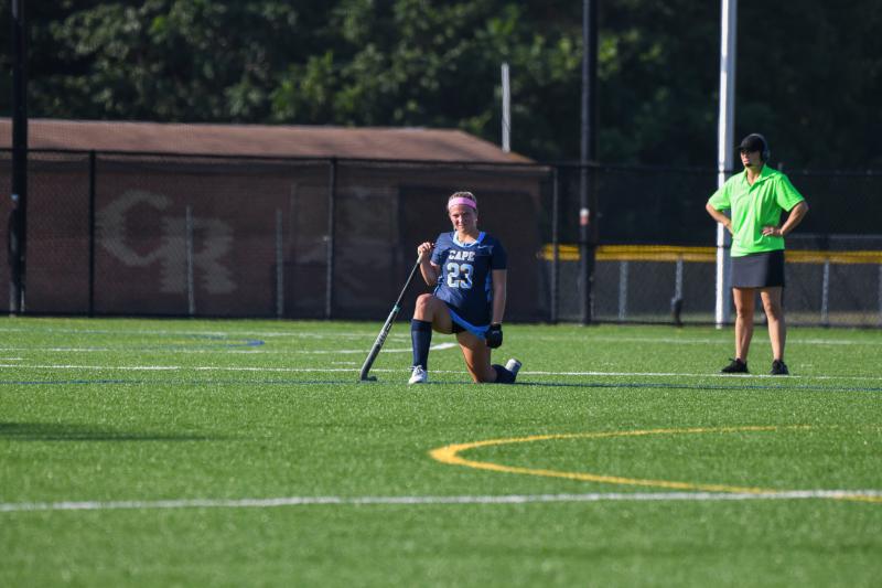 Lina Frederick kneels as her teammate Ally Diehl lies injured on the field.