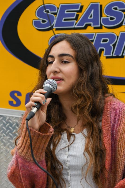 Sara Freih sings the national anthem at the Ashley Furio 5K at the Crooked Hammock.