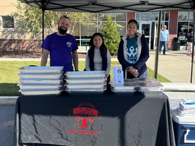 Serving tacos during the La Red Goes Purple event Oct. 18 are (l-r) Ernesto Torres, Gabriela Barrios-Ramirez, and Anabell Arias-Rosario. SUBMITTED PHOTO