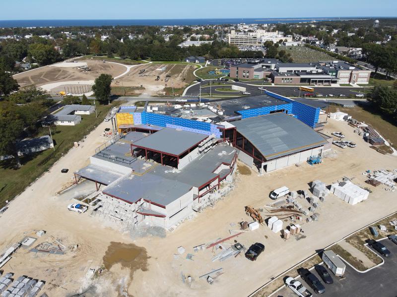At left, the building comprises a set of learning stairs that connects the gym, cafeteria and auditorium, as well as a media center that will be flooded with natural light. The gym is located in the domed roof to the right. Student classrooms will overlook athletic fields across Sussex Drive. NICK ROTH PHOTO