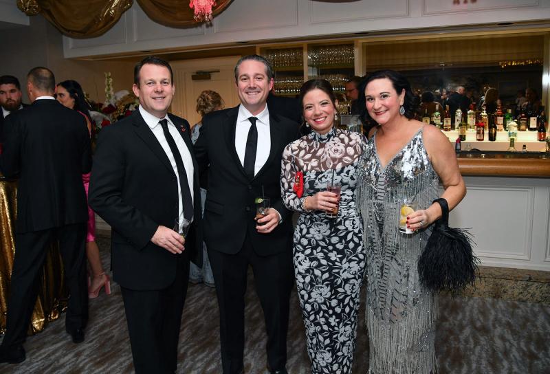 Enjoying a libation are (l-r) Tom Bain, Dr. Justin Elder and his wife Susan, and Jess Bain.