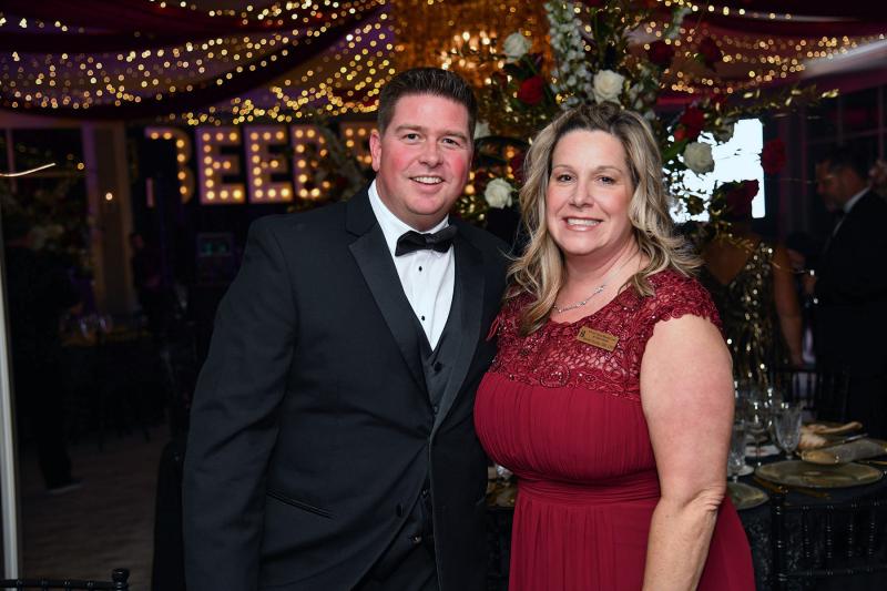 Danielle Socrates, vice president of value based care and operations, right, attends the Beebe Ball with her husband Jason.
