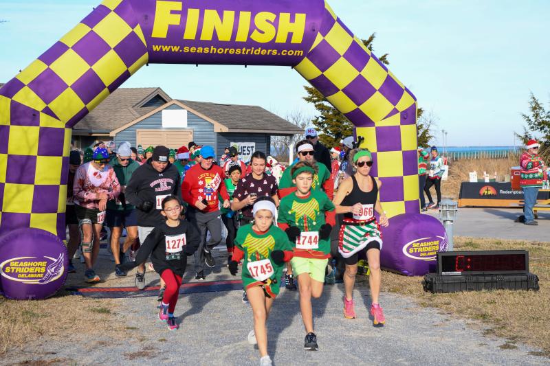 Ruby and Whit Leps charge to the front at the start of the Ugly Sweater 5K. DAVE FREDERICK PHOTOS