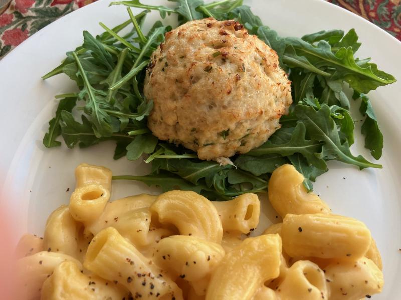 Comfort food with a touch of class, like this crab cake on baby arugula with mac & cheese, will warm any heart on Christmas Eve. JACK CLEMONS PHOTO
