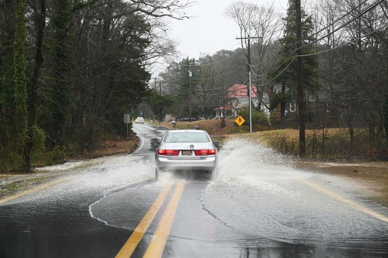 The low point in Atlantic Street in Milton is flooded, making it difficult for morning commuters to pass through. NICK ROTH PHOTO