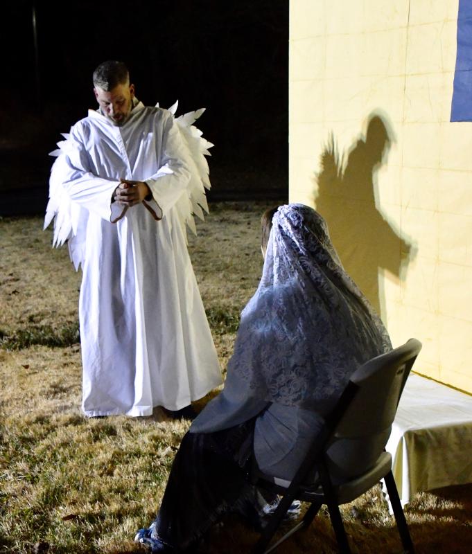 An angel, portrayed by Geno Poppitt, gives Mary, portrayed by Hope Muzzi, the news that she has been chosen to be the mother of the Son of God.