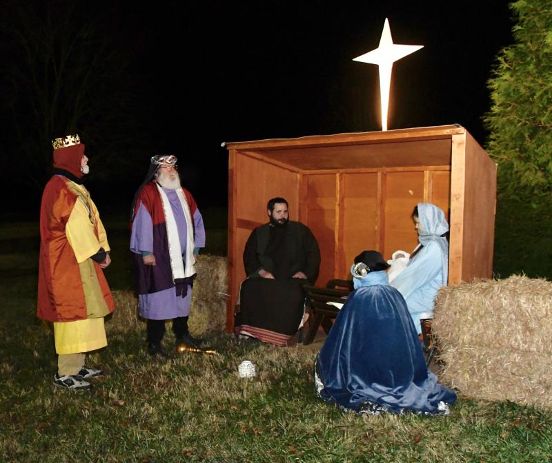 Baby Jesus has been born in a manger to Joseph, portrayed by Chad Fitzkee, and Mary, portrayed by Rachael Grahovac, as the three wise men (l-r) Glen Hall, Terry Sibley and (kneeling) Craig Cannon bring gifts of gold, frankincense and myrrh.