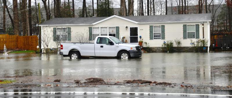 A house on Hudson Road has a water-filled front yard. Sections of Hudson Road were nearly impassable. RON MACARTHUR PHOTO