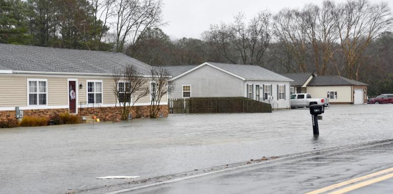 Several homes along Route 5 near the Hollyville and Hollymount roads traffic signal get all of the overflow from the road and neighboring properties. RON MACARTHUR PHOTO