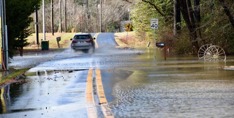 Water flows across Friendship Road off Route 5 on the way to Long Neck. RON MACARTHUR PHOTO