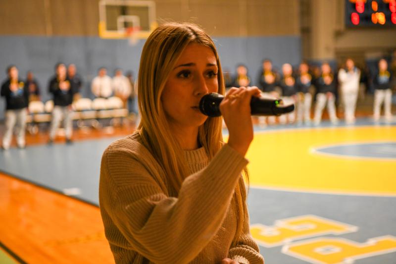 Emily Groll sings the national anthem.
