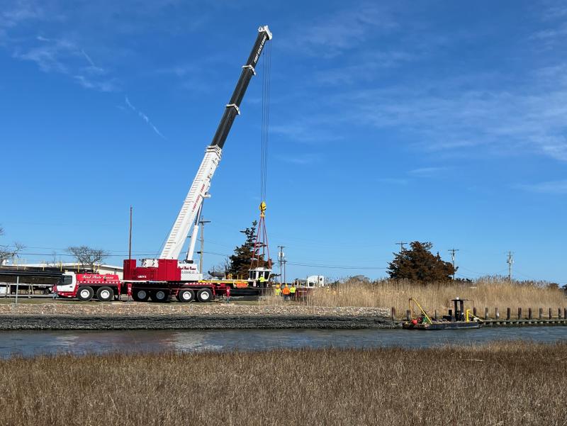 A large crane lifts dredging equipment from Roosevelt Inlet Feb. 20. The canal dredging was completed during the week of Feb. 12. BILL SHULL PHOTOS