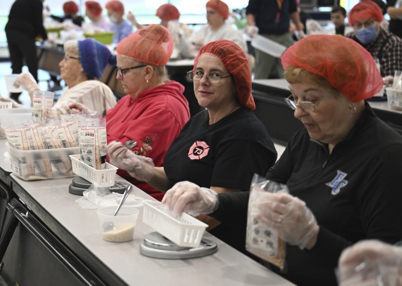 Staffing the measuring table, the last step before packaging the boxes, are (l-r) Carol Gartman, Linda Veleber, Theresa Huffman and Joyce MacPhee.