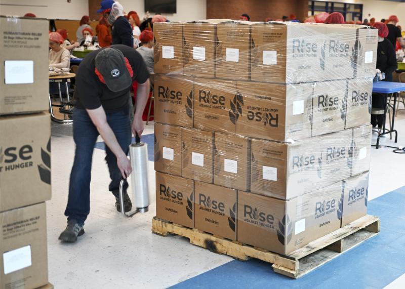 Boxes of packaged food are prepared for loading onto box trucks.
