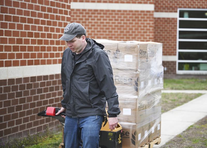 Ryan Ehmts pulls one of the many pallets of food to be loaded into the truck.