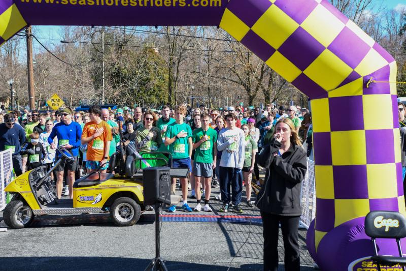 Emily Groll sings the national anthem before the Lucky Leprechaun 5K in Milton. DAVE FREDERICK PHOTOS