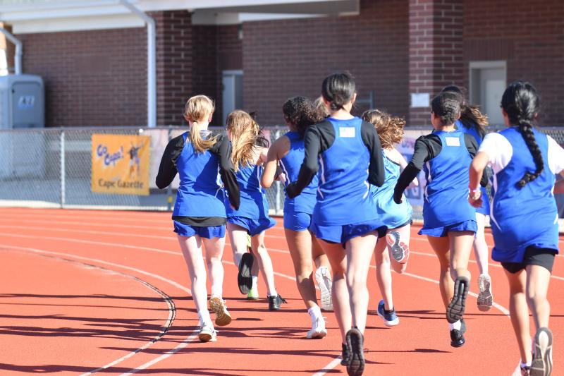 Girls round the bend at the start of the 1,600.