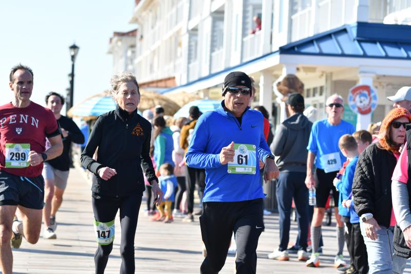 Debra Isser, 69, with bib 147 on her thigh, sets a 5K age-group state record with a time of 23:22.