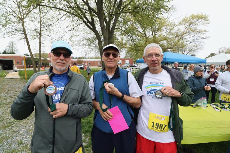 Showing off their medals as top three finishers in the male 70-and-over category are (l-r) John Walters of Lewes, Mike DeSanto of Milton, Vt., and Doug Repetti of Lewes.