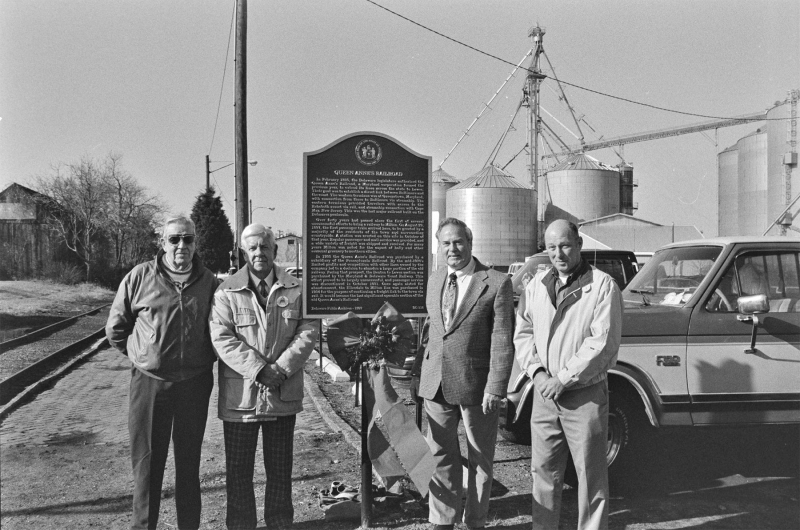 Shown at the Queen Anne's Railroad historic marker dedication in 1997 are (l-r) William Wagamon, president of the Milton Historical Society; Herman Black; Rep. George Carey; and Milton Mayor Jon Bushey. SOURCE: DELAWARE PUBLIC ARCHIVES
