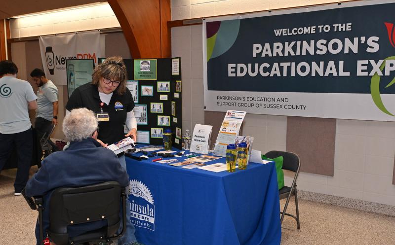 Holly Jones of Peninsula Home Care at Nanticoke speaks with a patient at the event.