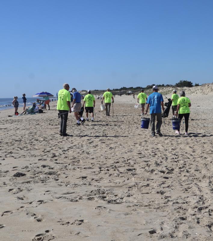 Volunteers start the journey down the beach looking for trash.