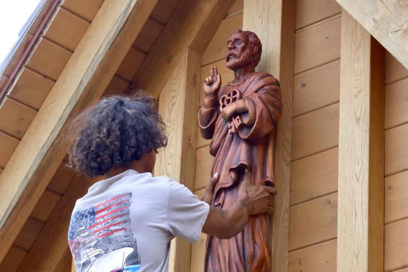 Mike Glanden of Burton Builders straightens the statue during installation June 25.