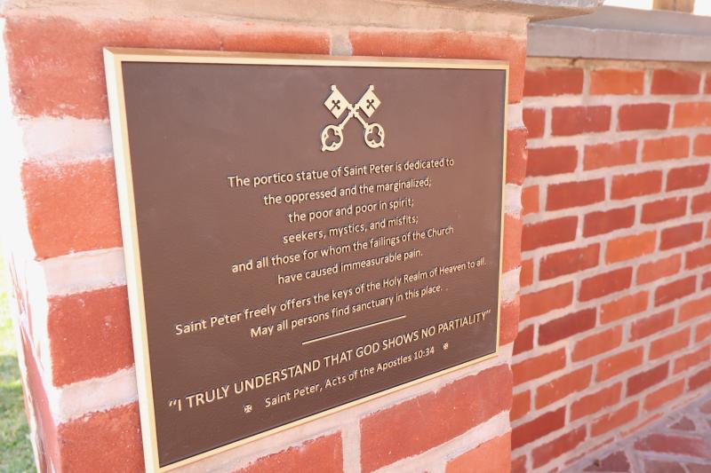 This plaque was placed on the portico, under the St. Peter statue, extolling the church’s mission of providing sanctuary to all.