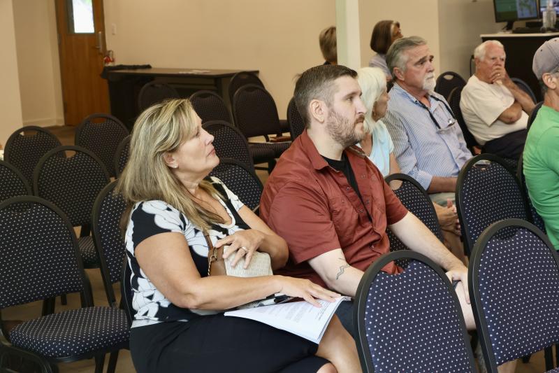 Margie Madigan, left, and her son, Stephen Provost, listen to Marijuana Commissioner Rob Coupe in Lewes July 18. They came to learn more about the application process in hopes of getting a license to grow and sell regulated, adult-use marijuana.