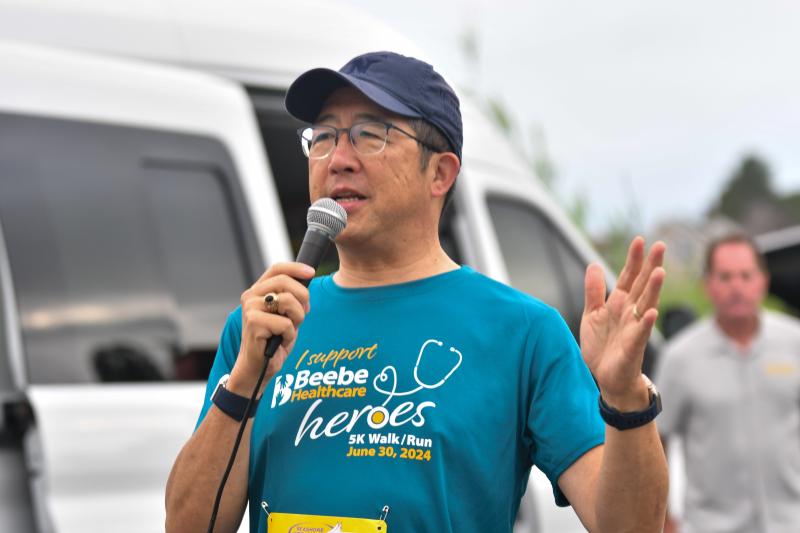 Beebe Healthcare CEO and President Dr. David Tam addresses runners before the Beebe Heroes 5K, in which he also ran.