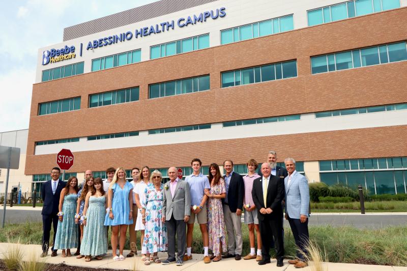 Beebe Healthcare leaders joined members of the Abessinio family for a ceremony the at the healthcare campus near Rehoboth Beach that now bears their name. Shown are (l-r) Dr. David Tam, Beebe Healthcare president and CEO; family members Jenn Abessinio, Vincent Abessinio, Lilly Abessinio, Paige Abessinio, Michael Cool, Anna Cool, Mike Cool, Mardee Cool, Mary Abessinio, Rocco A. Abessinio, Rocco P. Abessinio, Kristen Abessinio, Peter Abessinio and August Abessinio; Tom Protack, Beebe Medical Foundation president; Christian Hudson, Beebe Medical Foundation board chair; and Mike Meoli, Beebe Healthcare board chair. BILL SHULL PHOTOS